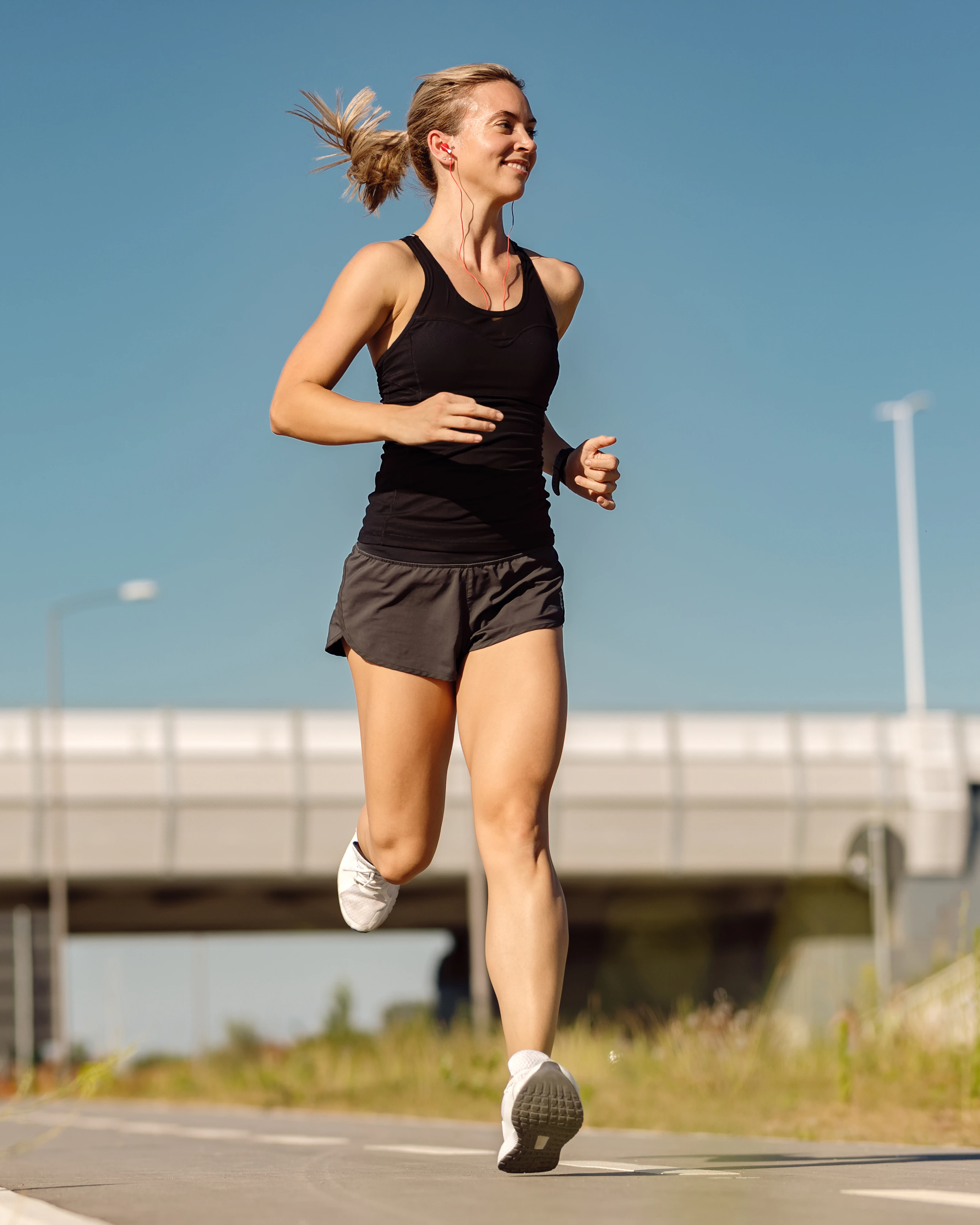 A woman running on an open road in the morning